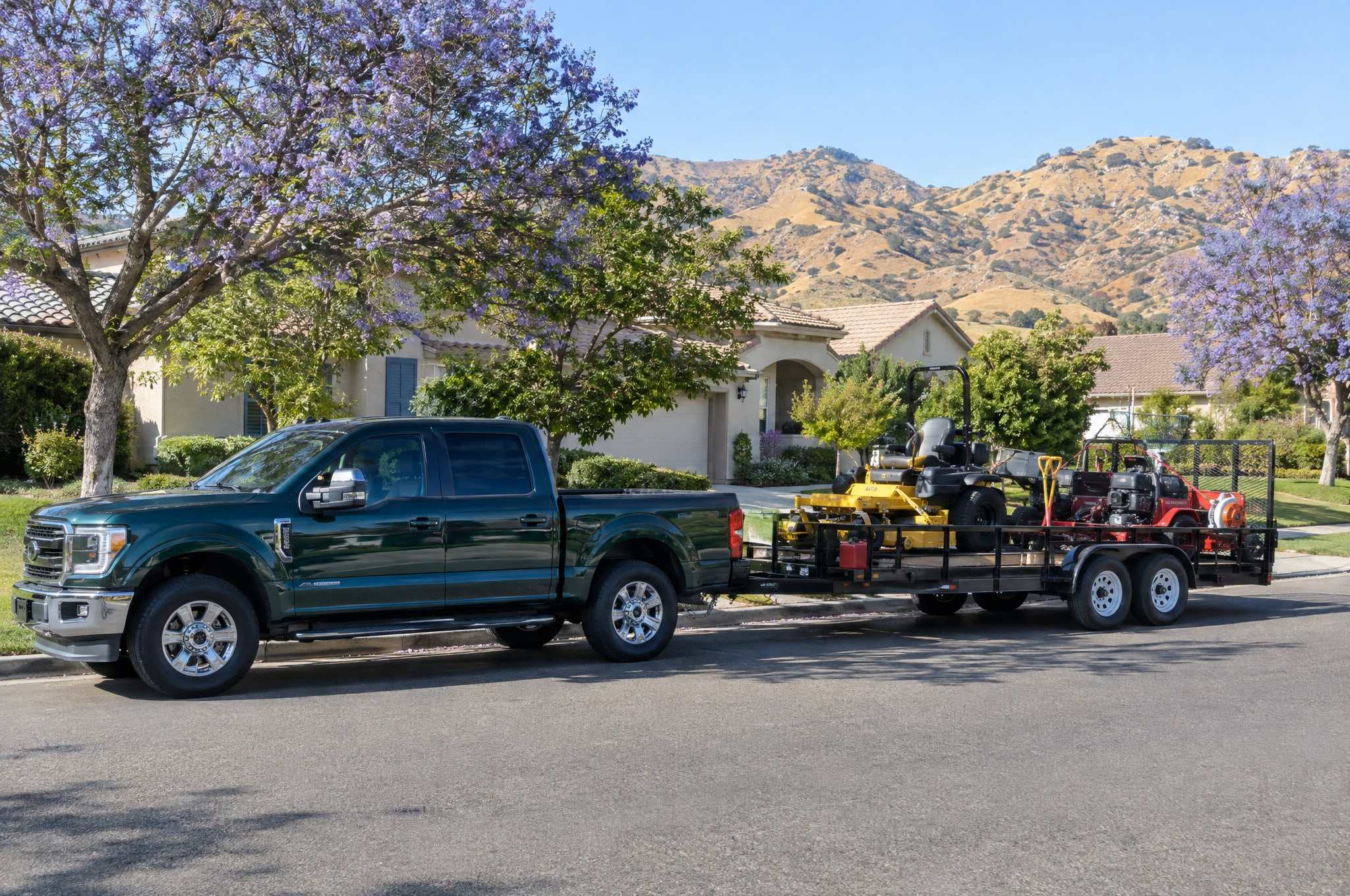 Lawn care truck and trailer parked on a tree-lined Santa Clarita Valley street